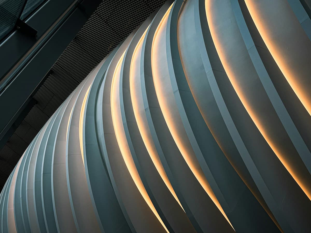 Curving architectural elements illuminated in warm light
